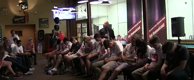 Volunteers reacting during a clean comedy hypnosis show
